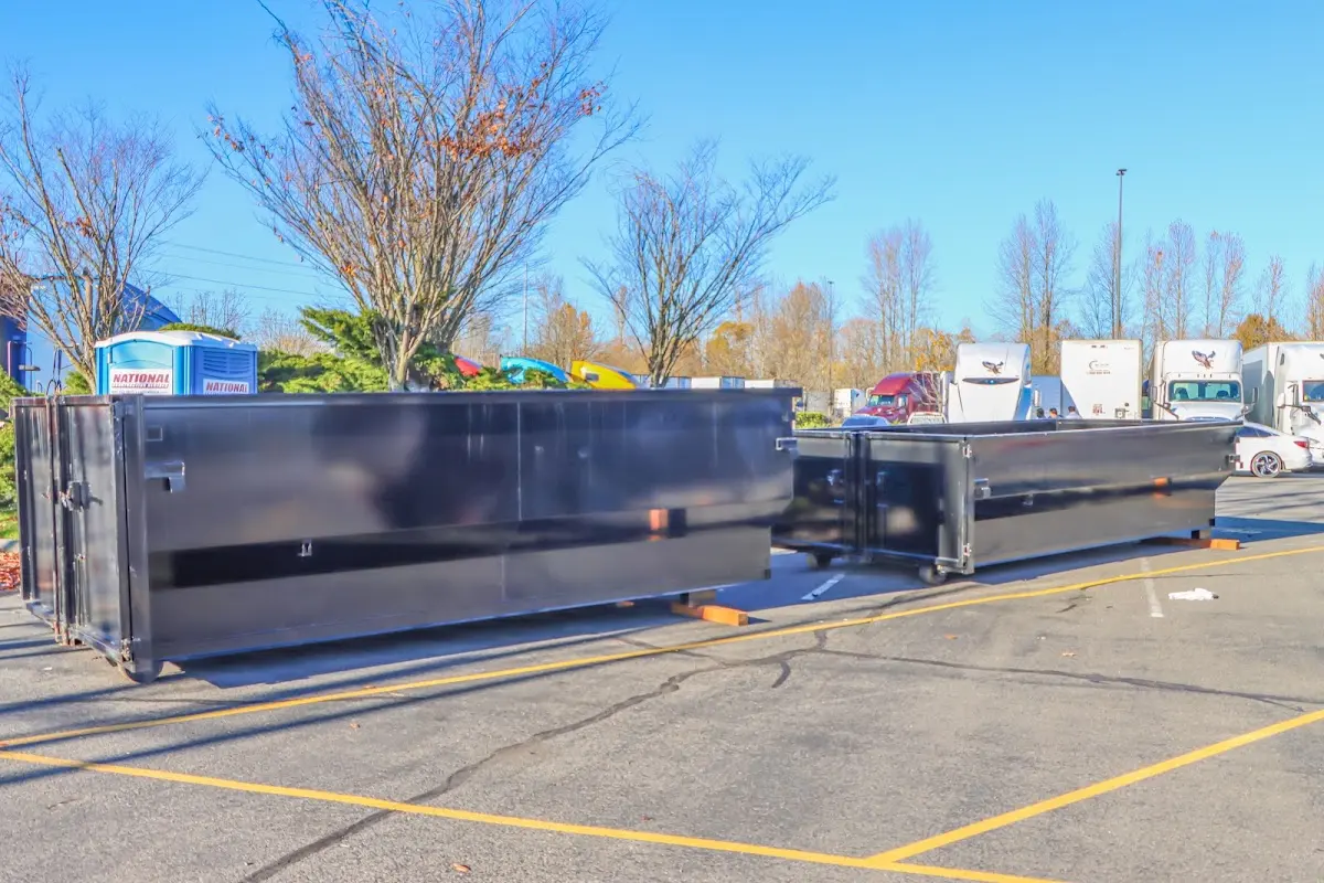 Professional dumpster rental service with roll-off container on residential driveway in Sweetwater